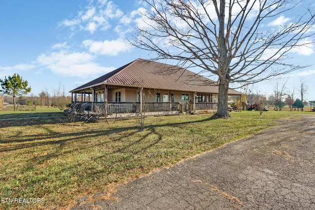 a front view of a house with a yard table and chairs