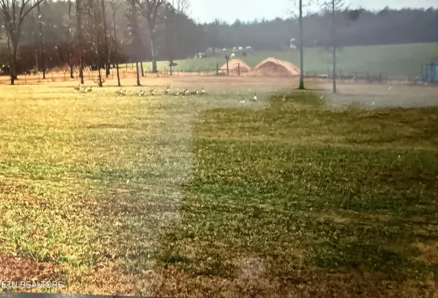 a swimming pool with outdoor seating and yard