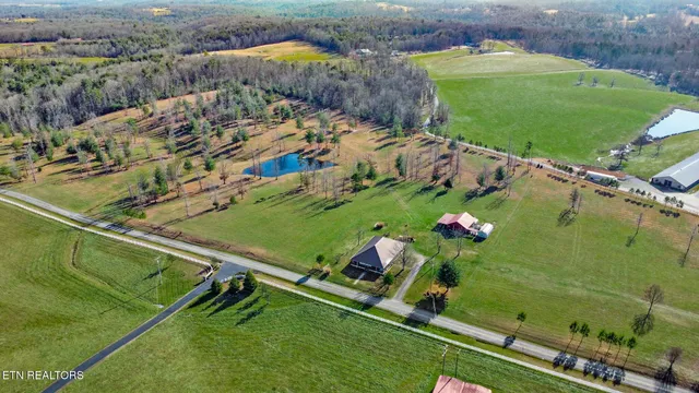 an aerial view of a house with a yard basket ball court