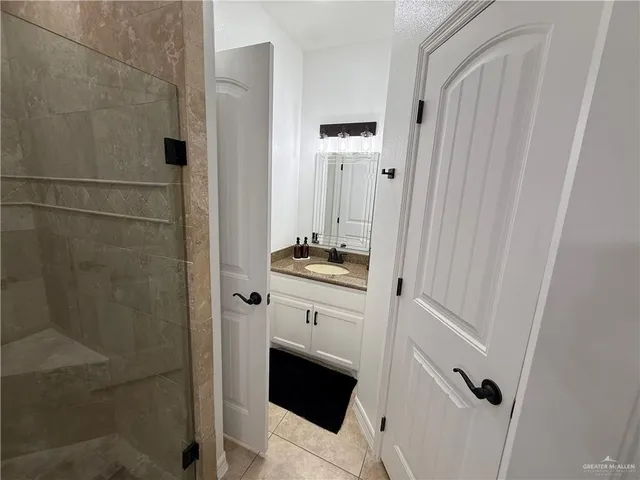 a bathroom with double vanity and a shower