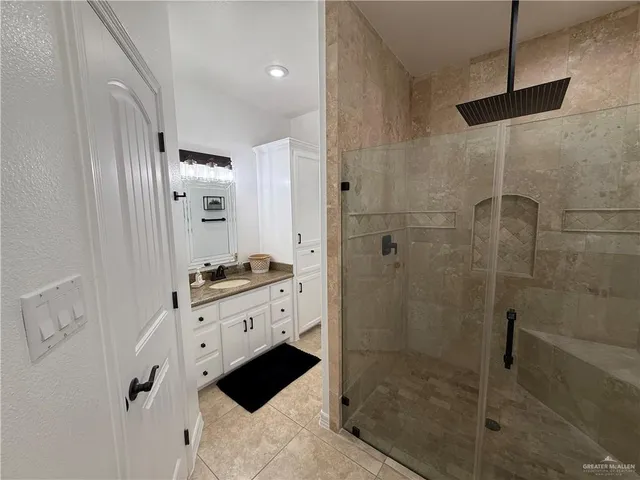a bathroom with a shower and a sink