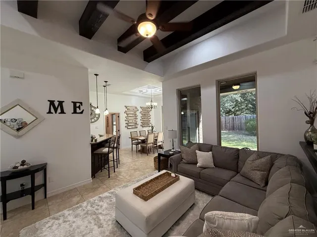 a living room with furniture ceiling fan and a window