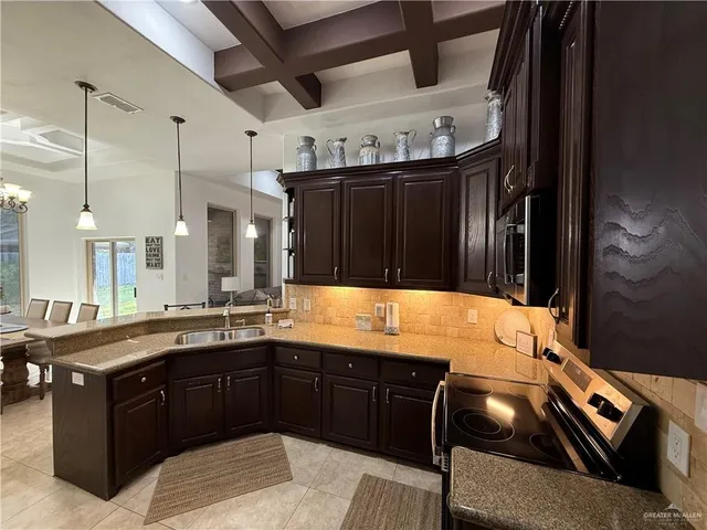 a kitchen with a sink and a stove