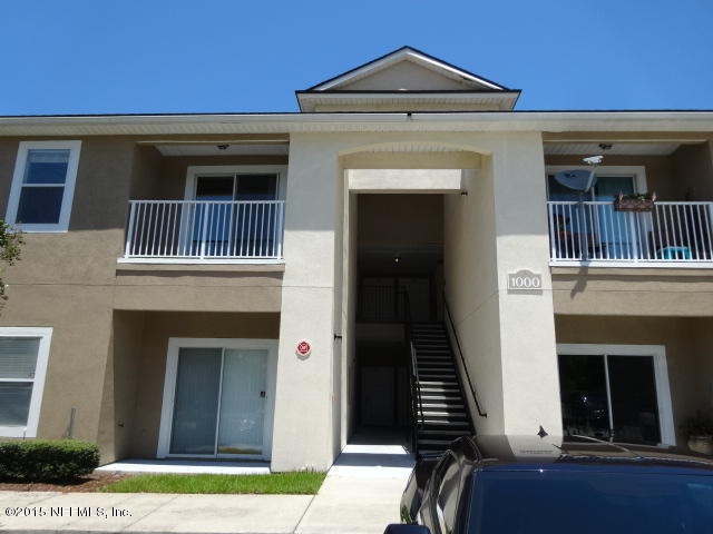 7920 Merrill Road, Unit 1013 Jacksonville, FL 32277 - Photo 2 of 11 a front view of a house with a yard