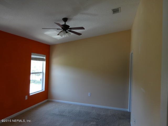 7920 Merrill Road, Unit 1013 Jacksonville, FL 32277 - Photo 7 of 11 an empty room with windows and fan