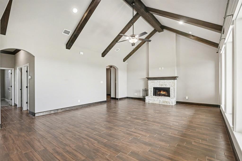 104 Stanford Lane Springtown, TX 76082 - Photo 11 of 28 a view of empty room with wooden floor and fireplace