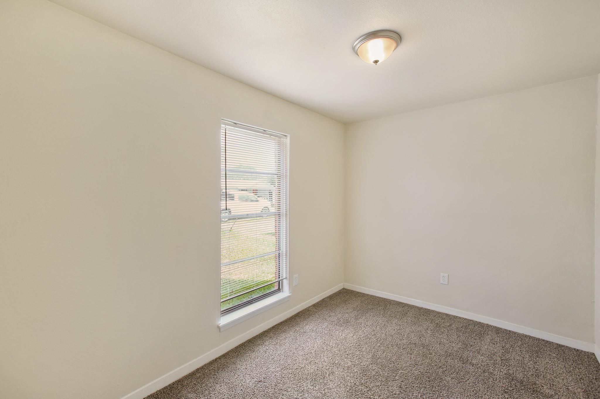 5415 3 Rd Street, Unit 1 Danbury, TX 77534 - Photo 3 of 8 an empty room with windows