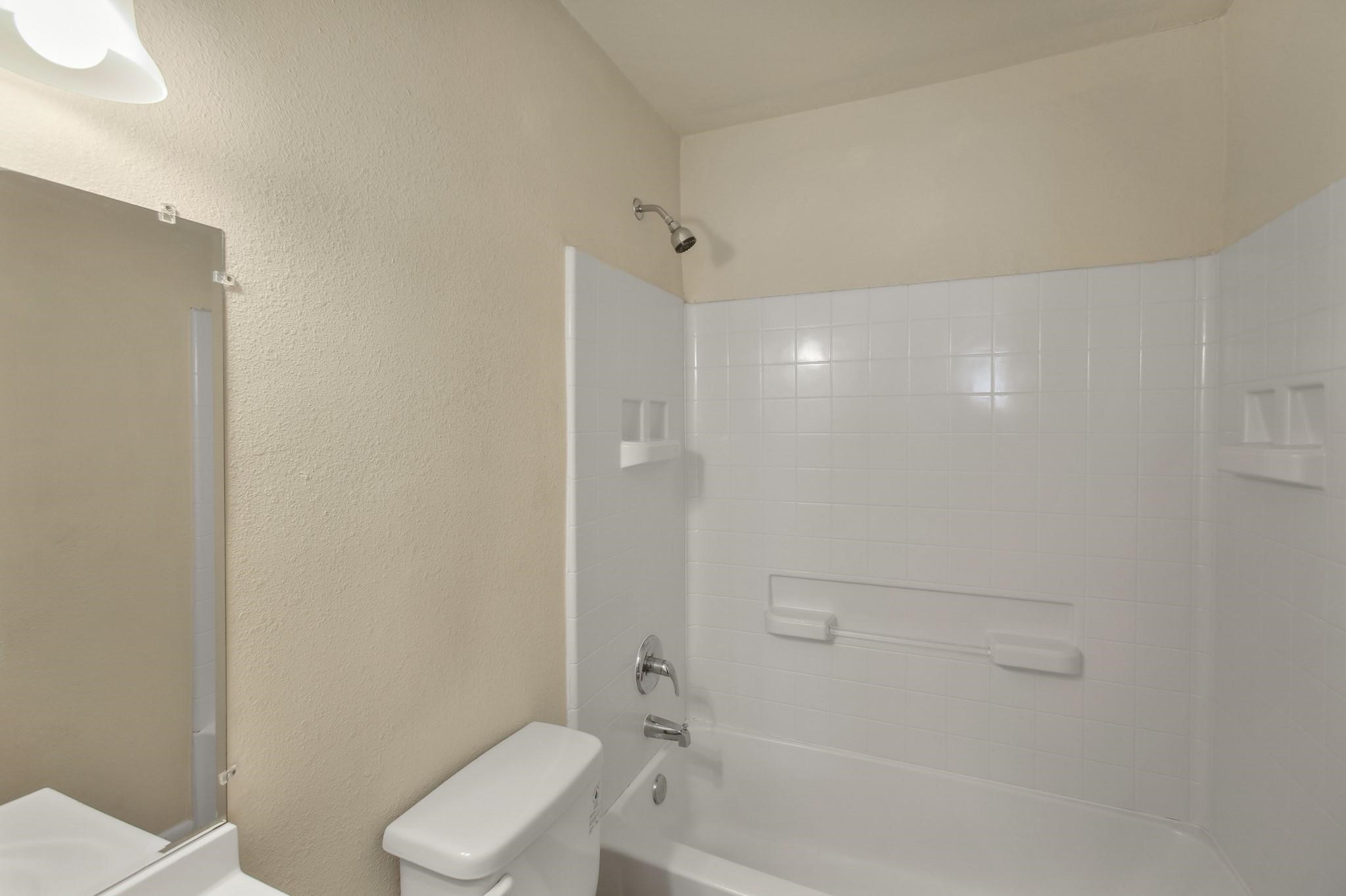 5415 3 Rd Street, Unit 1 Danbury, TX 77534 - Photo 5 of 8 a bathroom with a toilet and shower