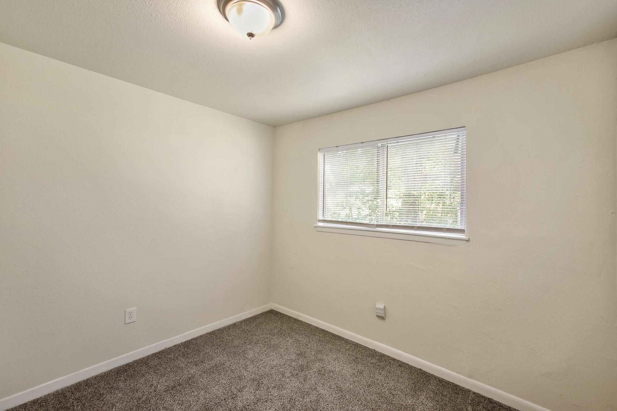 5415 3 Rd Street, Unit 1 Danbury, TX 77534 - Photo 7 of 8 an empty room with windows