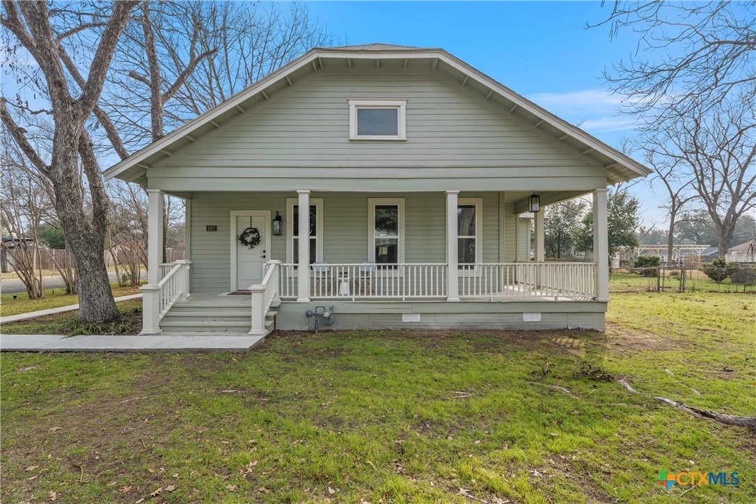 a view of a house with a yard patio and fire pit