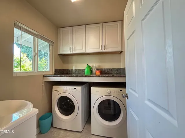 a utility room with sink dryer and washer