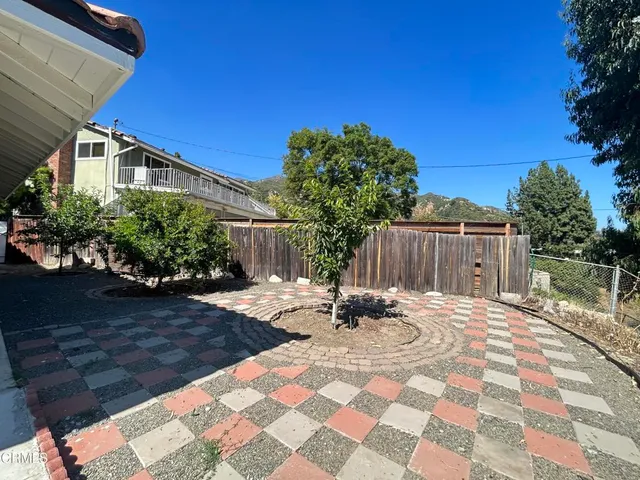 a view of a backyard with sitting area