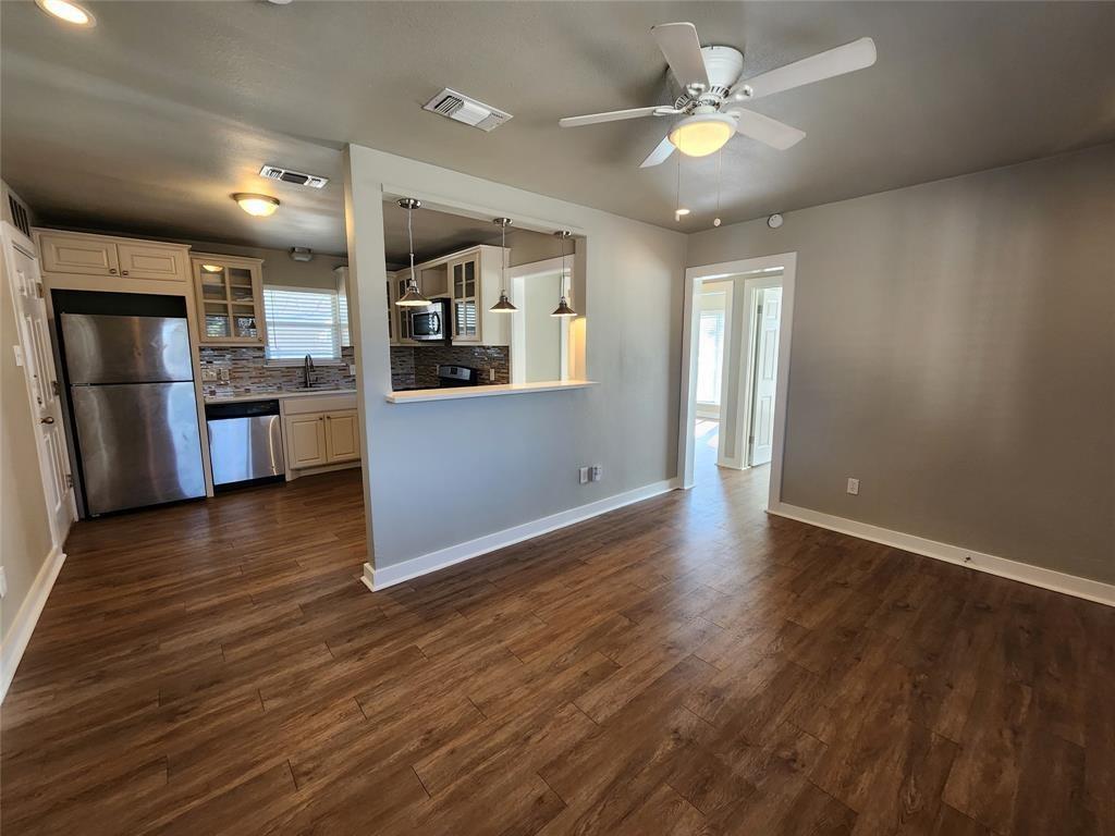 2708 St Edwards Circle, Unit A Austin, TX 78704 - Photo 3 of 13 Unfurnished living room with ceiling fan and dark wood-type flooring