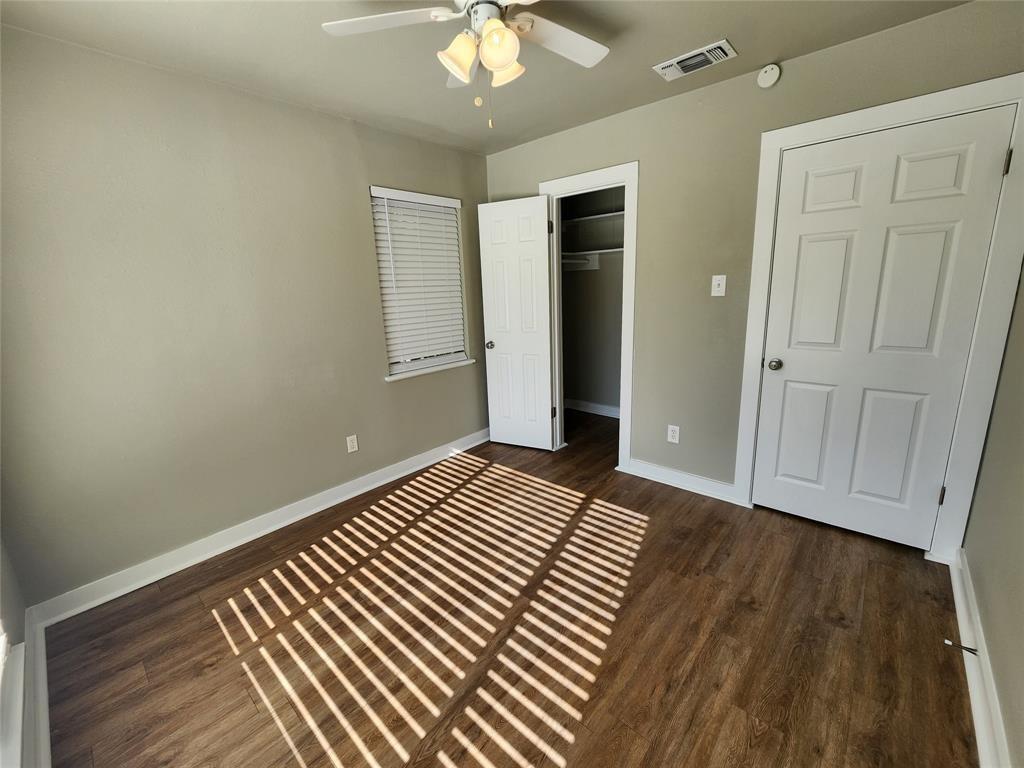 2708 St Edwards Circle, Unit A Austin, TX 78704 - Photo 6 of 13 Unfurnished bedroom with a closet, a ceiling fan, and dark wood-style floors