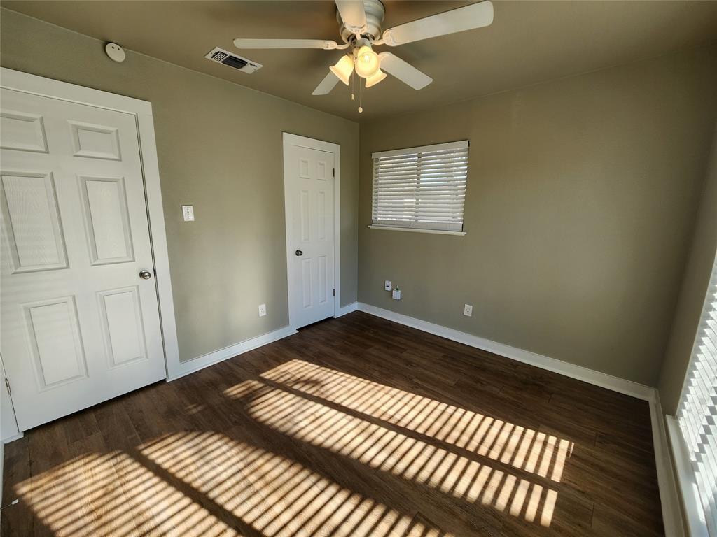 2708 St Edwards Circle, Unit A Austin, TX 78704 - Photo 8 of 13 Unfurnished bedroom featuring dark wood-style floors, ceiling fan, and a closet