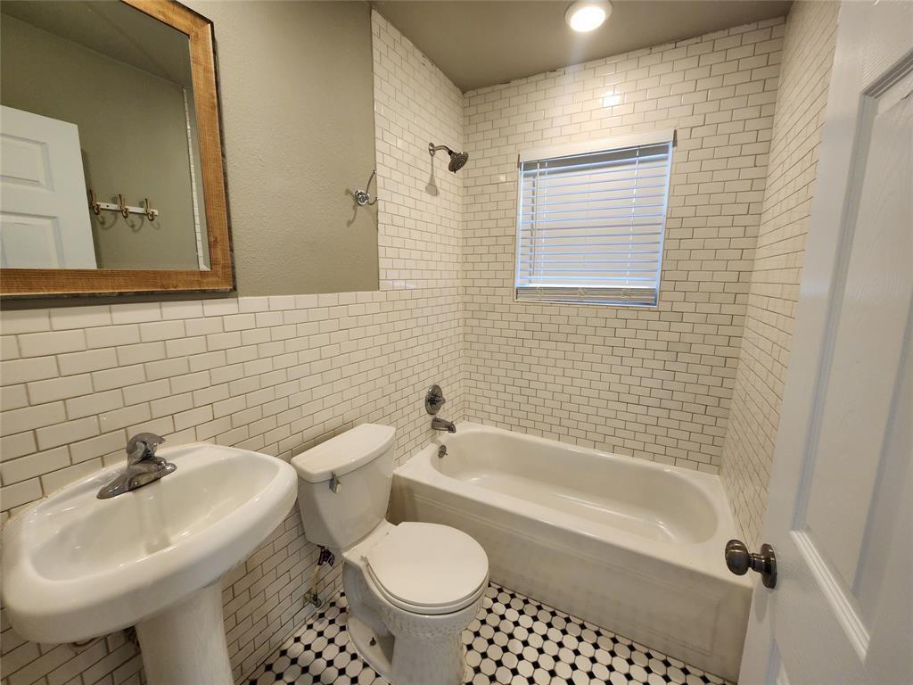 2708 St Edwards Circle, Unit A Austin, TX 78704 - Photo 9 of 13 Bathroom with tile walls and washtub / shower combination