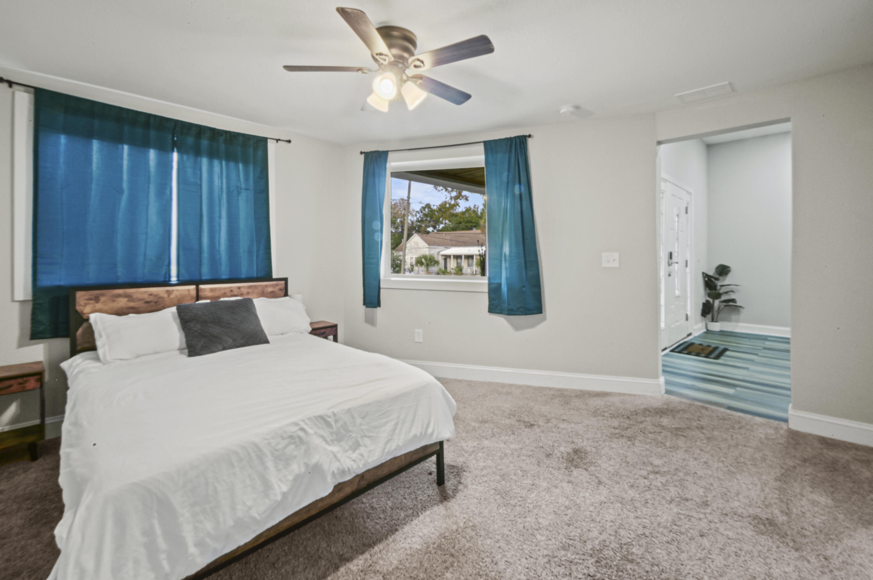 23 East Brainerd Street Pensacola, FL 32501 - Photo 13 of 25 a bedroom with a large bed and a chandelier fan