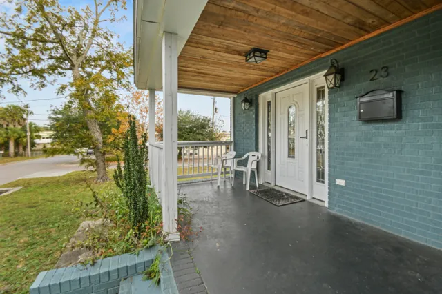 a view of a porch with furniture and garden