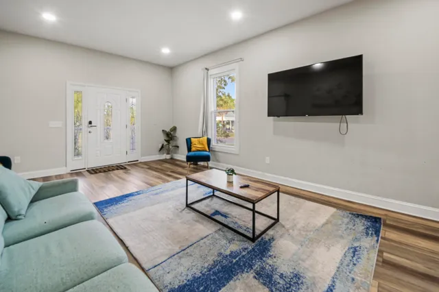a living room with furniture and a rug