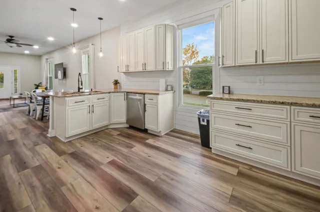 a bedroom with a large bed and a chandelier fan