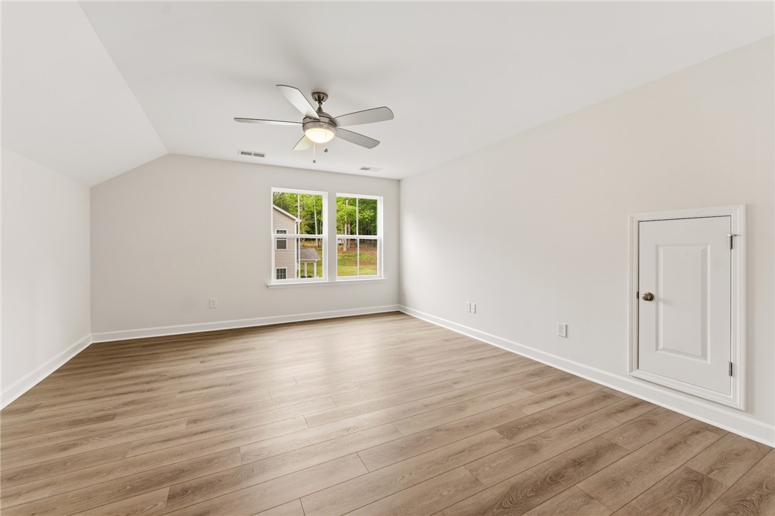 110 Lakeside Drive Anderson, SC 29621 - Photo 30 of 34 This bright bedroom features a vaulted ceiling and elegant hardwood flooring.
