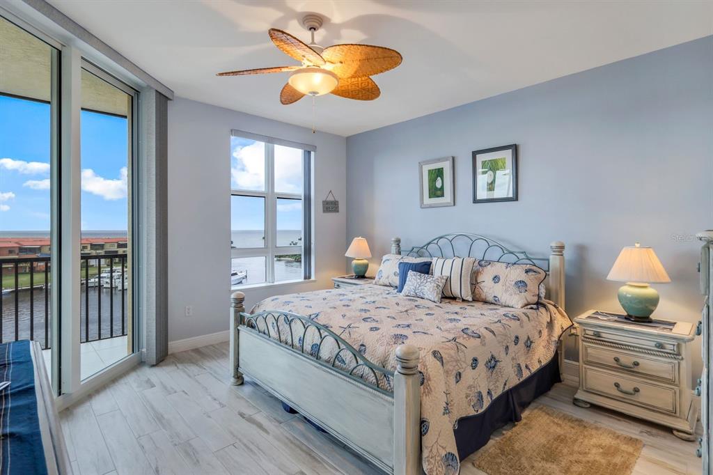 3313 Sunset Key Circle, Unit 404 Punta Gorda, FL 33955 - Photo 14 of 49 a bedroom with a bed and wooden floor