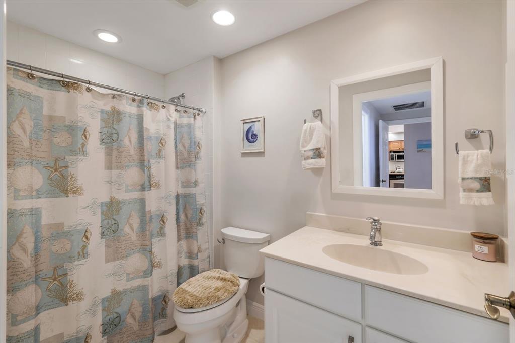 3313 Sunset Key Circle, Unit 404 Punta Gorda, FL 33955 - Photo 19 of 49 a bathroom with a sink toilet vanity and shower