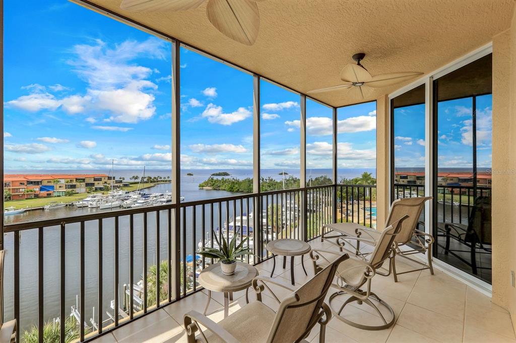 3313 Sunset Key Circle, Unit 404 Punta Gorda, FL 33955 - Photo 6 of 49 a view of a balcony with furniture and floor to ceiling window