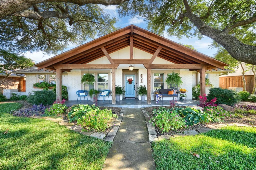 a view of a house with garden and pathway