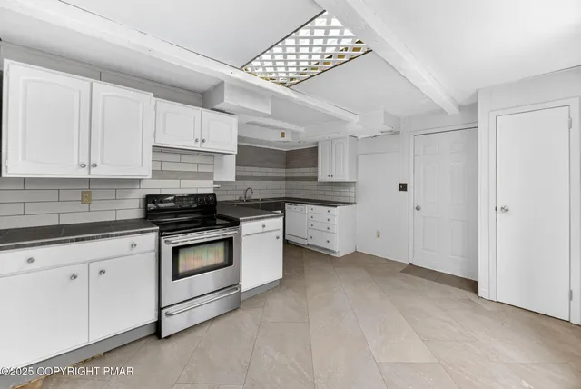 a kitchen with stainless steel appliances granite countertop a sink and cabinets