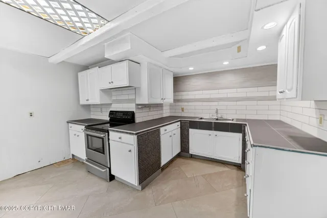 a kitchen with stainless steel appliances granite countertop a stove sink and cabinets