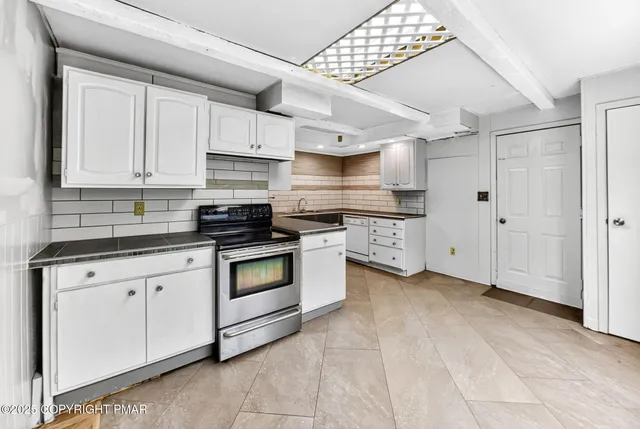 a kitchen with stainless steel appliances granite countertop a sink and a stove