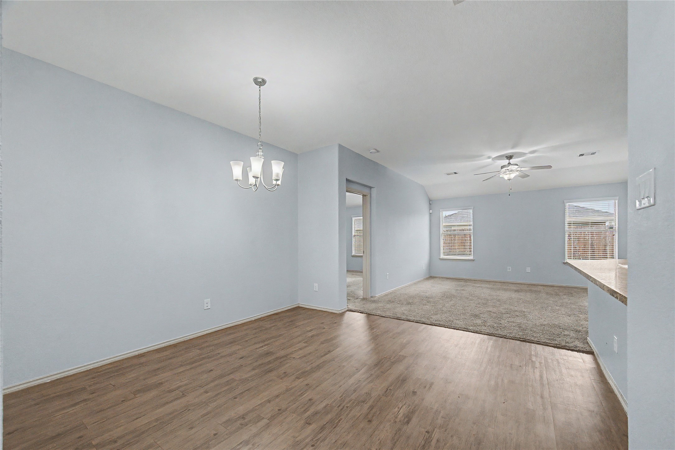16430 Rodeo River Road Houston, TX 77049 - Photo 15 of 34 a view of an empty room with wooden floor and a ceiling fan