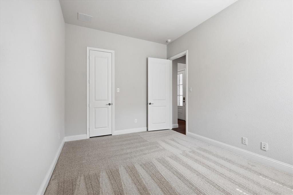 4017 Alpine Street Midlothian, TX 76065 - Photo 28 of 37 Neutral-toned interior with light grey walls, white trim, and light-colored patterned carpet