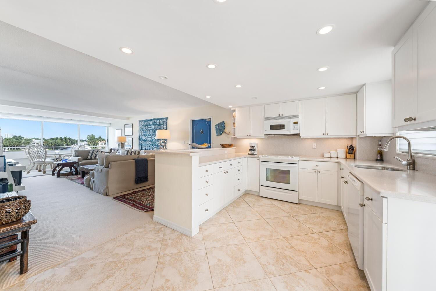215 North Birch Road, Unit 4C Fort Lauderdale, FL 33304 - Photo 12 of 32 a kitchen with cabinets a sink and white stainless steel appliances