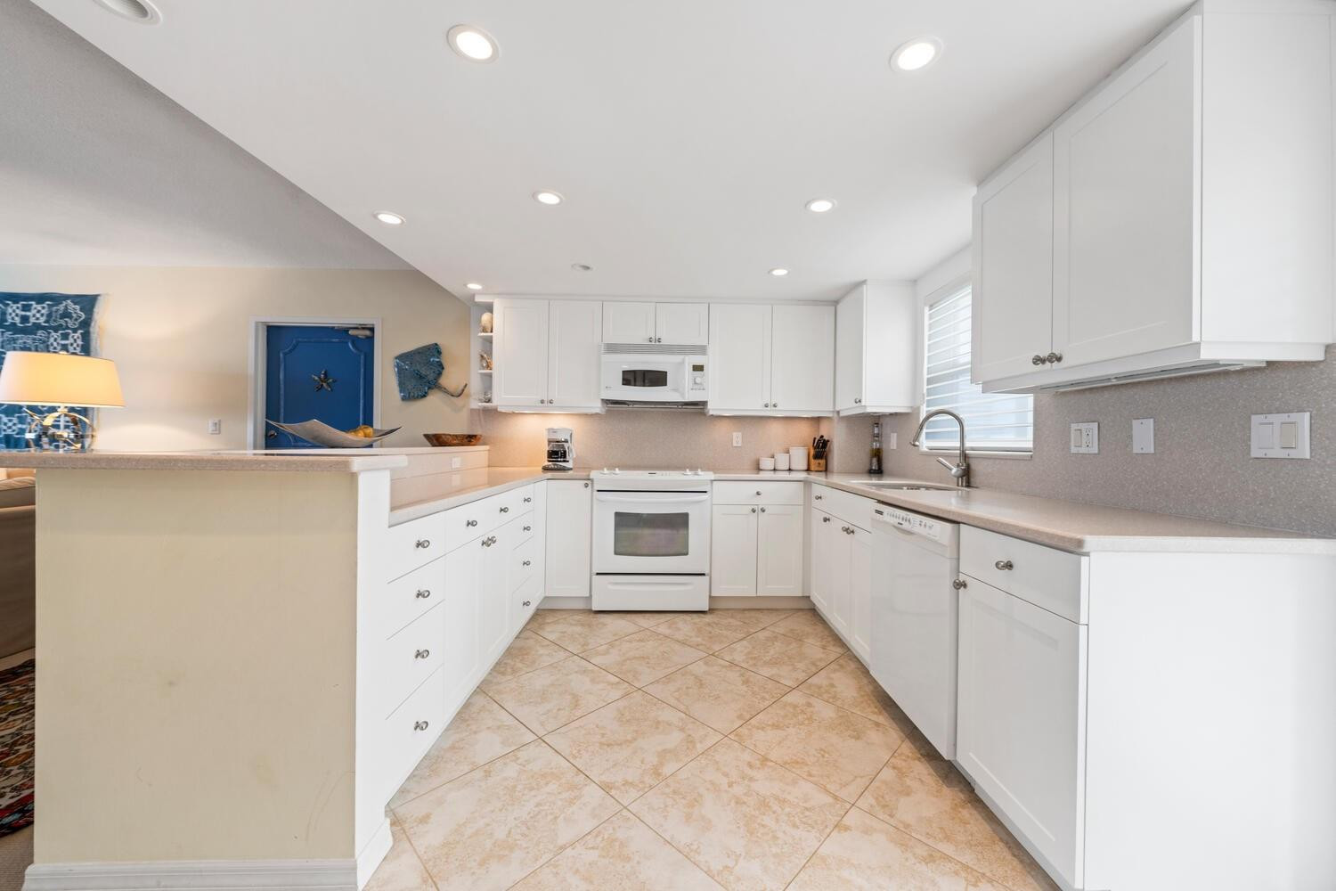 215 North Birch Road, Unit 4C Fort Lauderdale, FL 33304 - Photo 15 of 32 a kitchen with granite countertop white cabinets and white stainless steel appliances