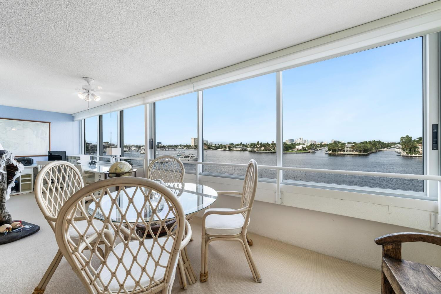 215 North Birch Road, Unit 4C Fort Lauderdale, FL 33304 - Photo 17 of 32 a dining room with furniture and a floor to ceiling window