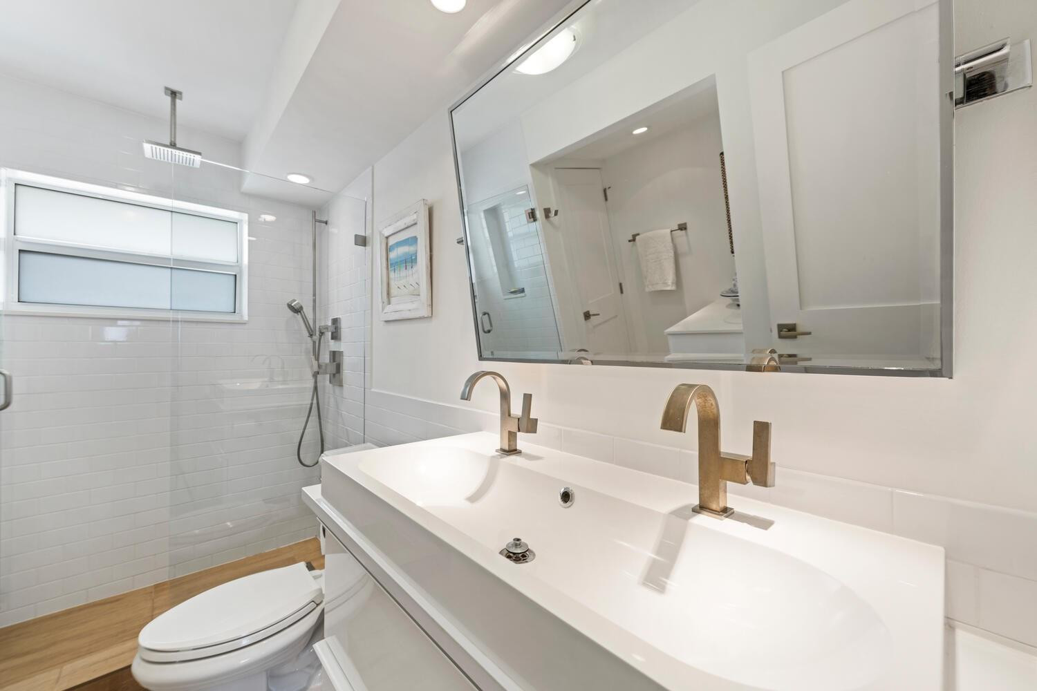 215 North Birch Road, Unit 4C Fort Lauderdale, FL 33304 - Photo 23 of 32 a bathroom with a sink a toilet and a mirror