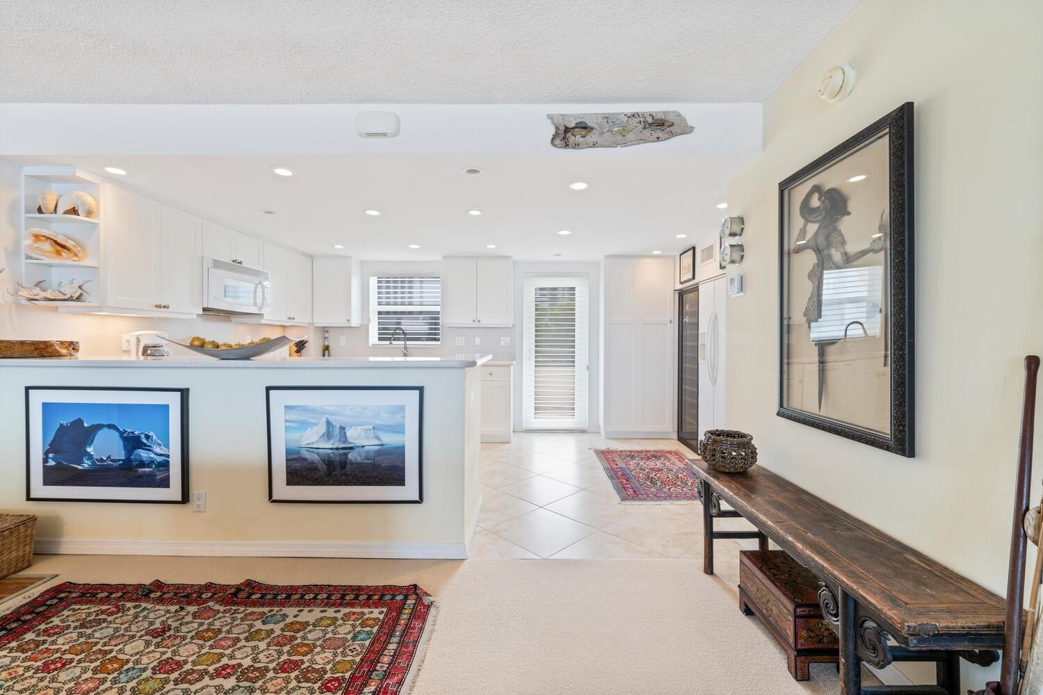215 North Birch Road, Unit 4C Fort Lauderdale, FL 33304 - Photo 4 of 32 a living room with stainless steel appliances furniture a rug and a window