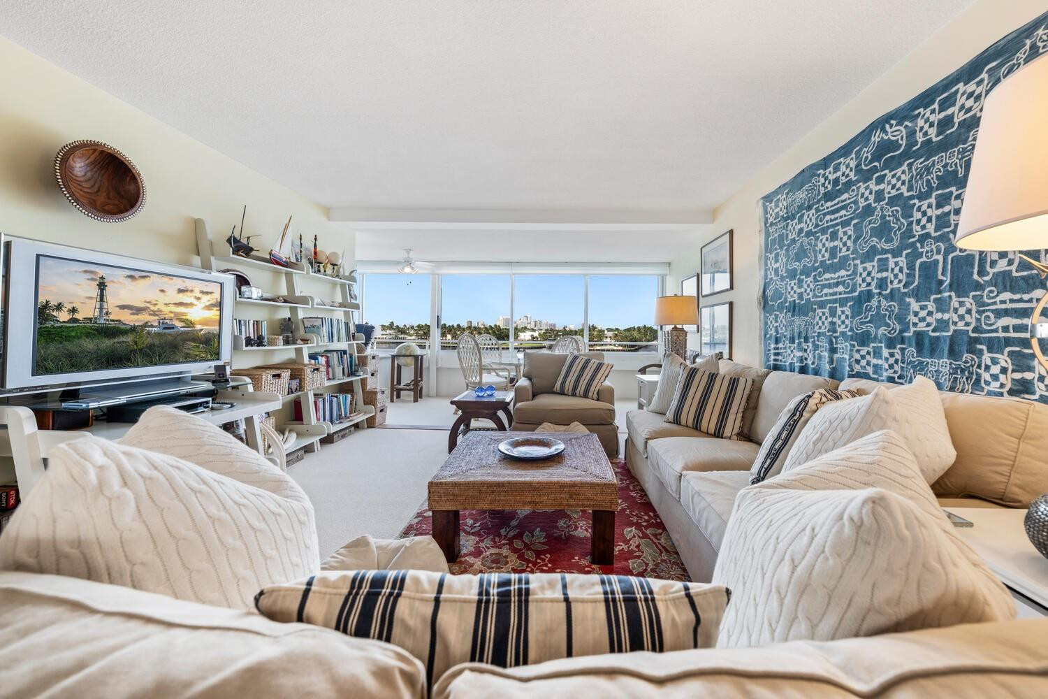 215 North Birch Road, Unit 4C Fort Lauderdale, FL 33304 - Photo 6 of 32 a living room with furniture a flat screen tv and a large window