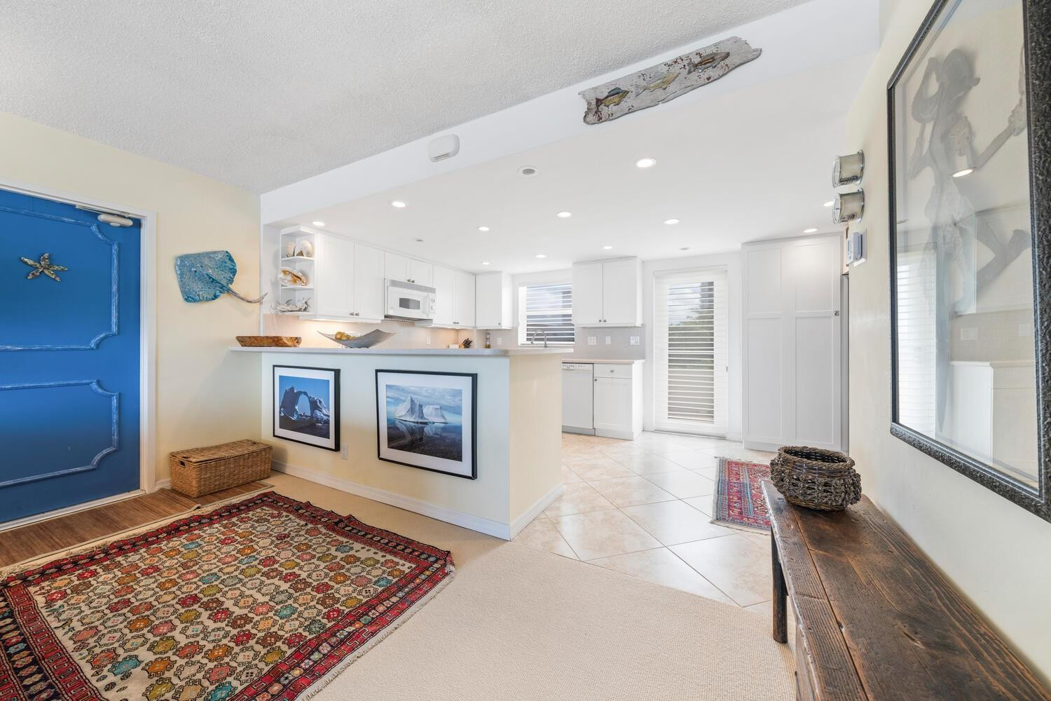 215 North Birch Road, Unit 4C Fort Lauderdale, FL 33304 - Photo 7 of 32 a living room with stainless steel appliances furniture a rug and a fireplace