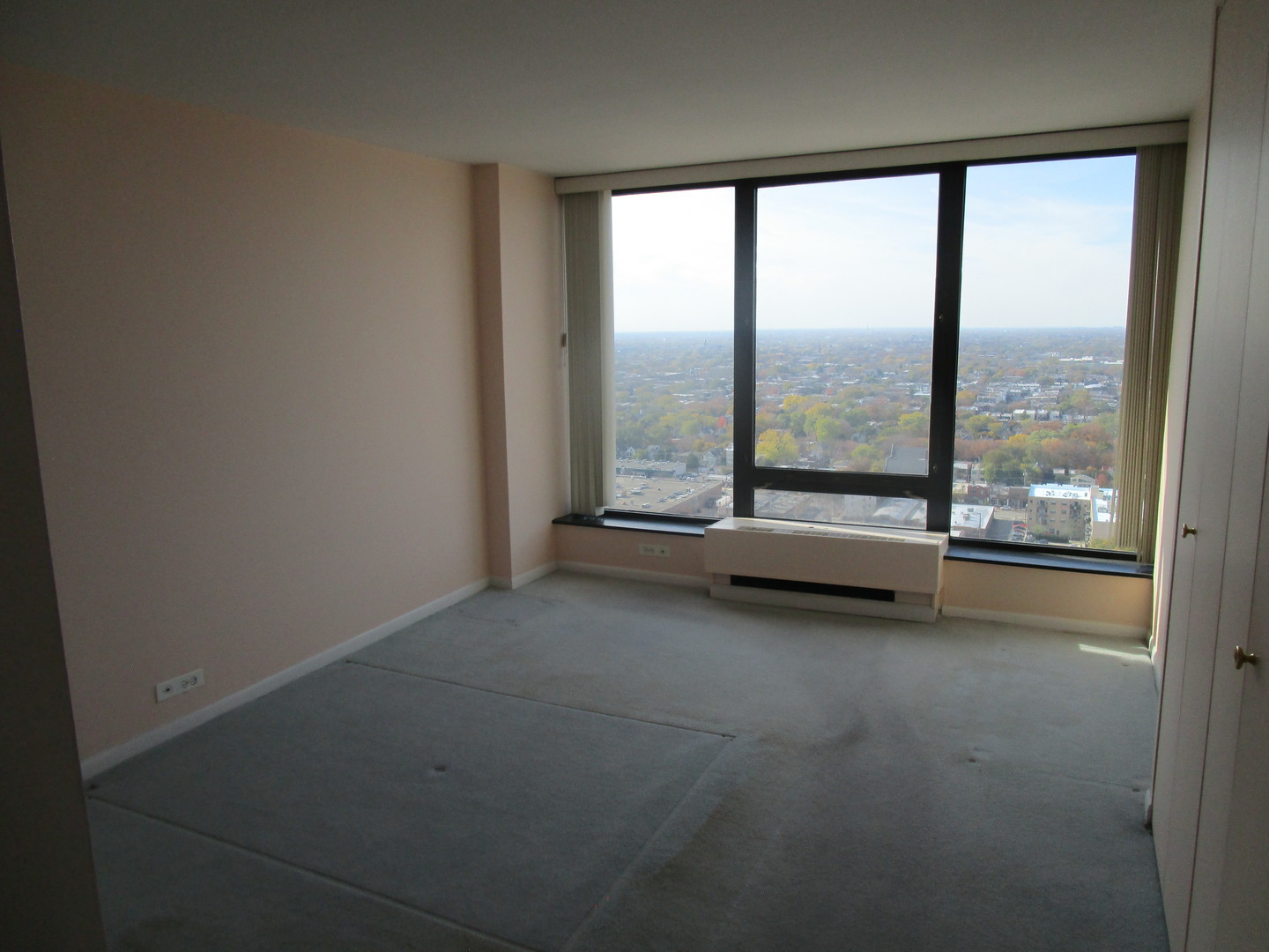 5445 North Sheridan Road, Unit 3311 Chicago, IL 60640 - Photo 11 of 15 an empty room with sliding glass door and windows