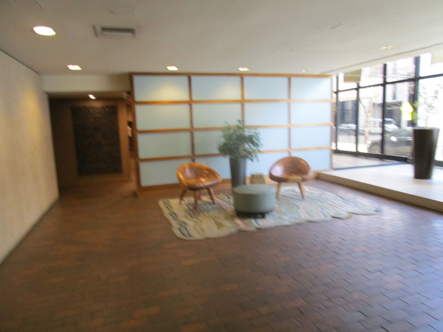 5445 North Sheridan Road, Unit 3311 Chicago, IL 60640 - Photo 2 of 15 a view of a room with wooden floor and a window