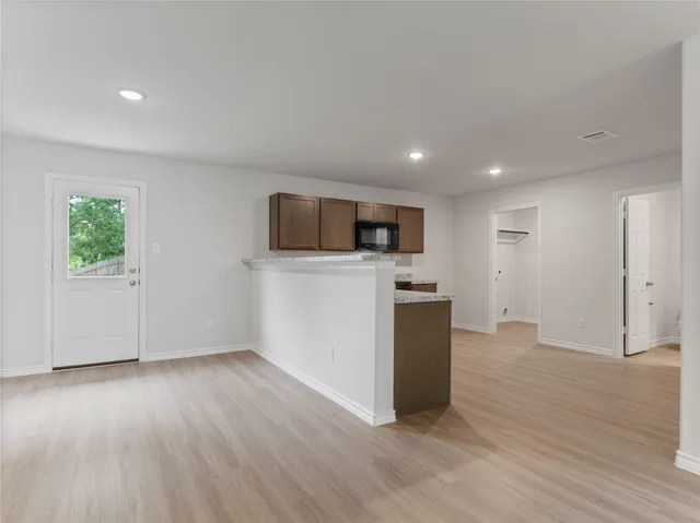 a view of a kitchen with a microwave and a stove