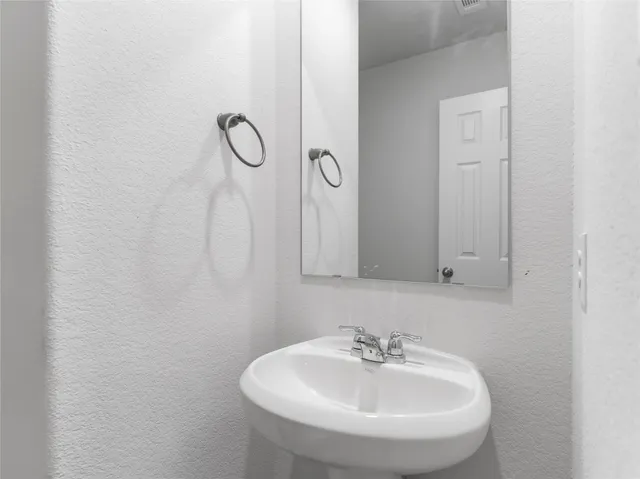 a bathroom with a sink and mirror