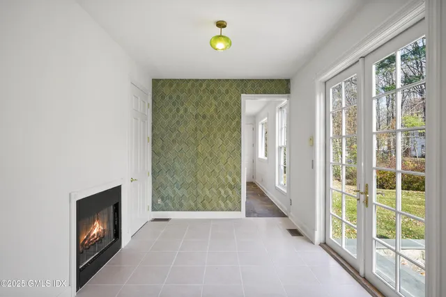 a view of a hallway with a fireplace and a window