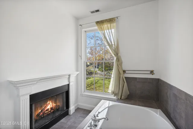 a living room with a fireplace and a window