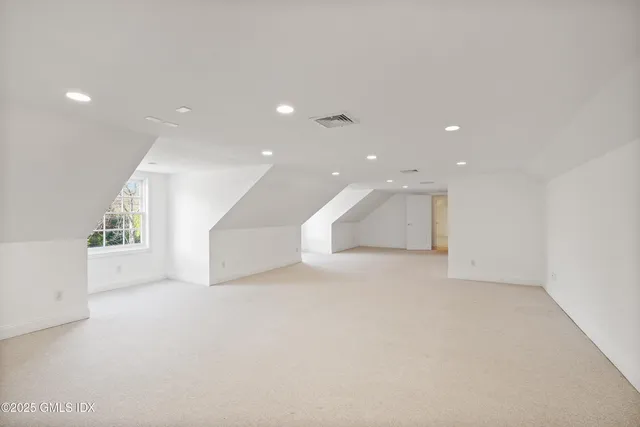 an empty room with windows and pillars in it