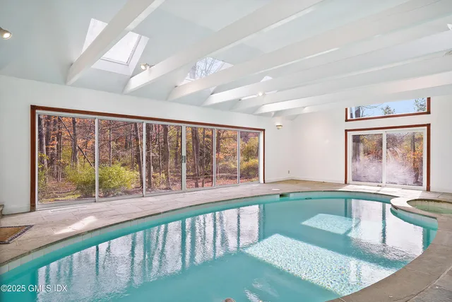 a view of a large swimming pool and outdoor seating