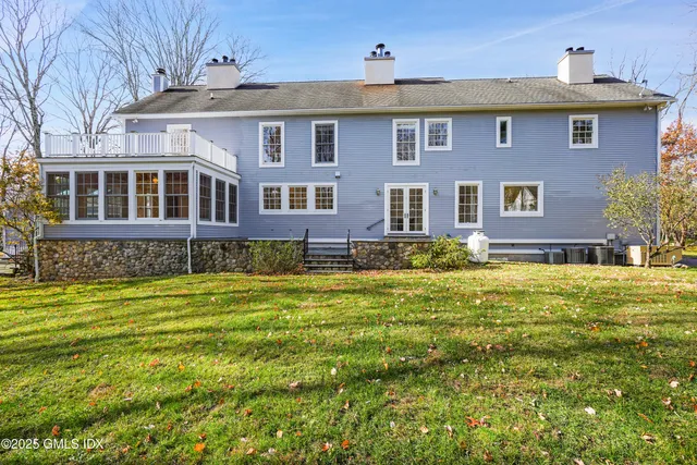 a view of a house with a yard and tree s